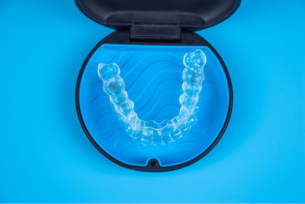 Invisalign transparent braces in a plastic case.