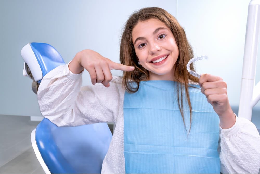 teen girl in white shirt during teeth treatment
