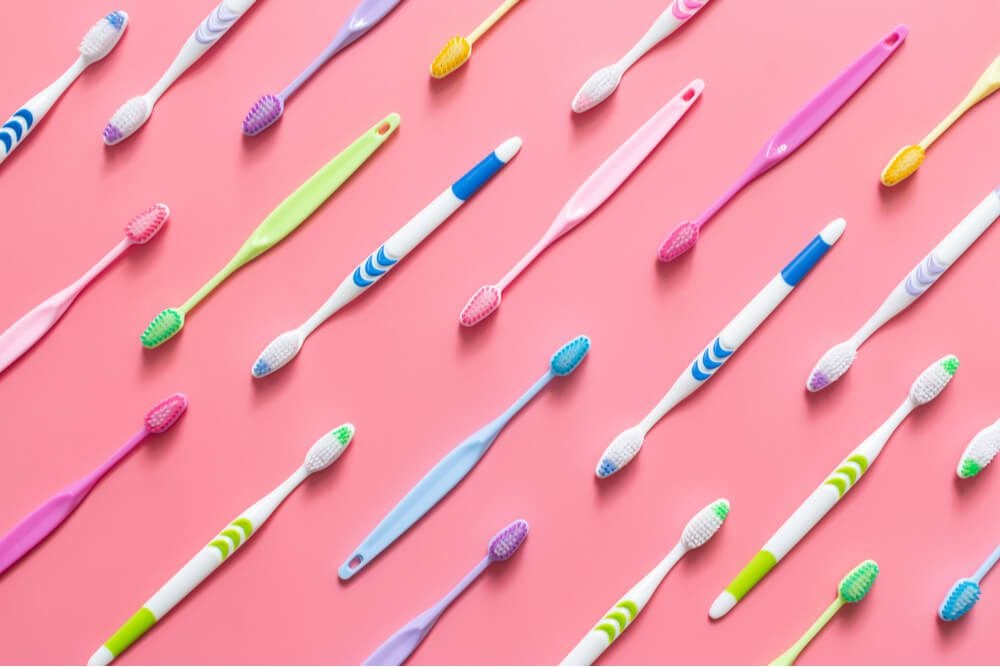 Top view of toothbrushes in colorful on pastel color
